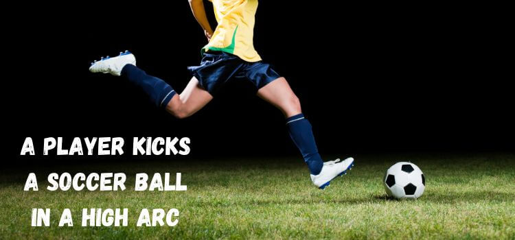 a player kicks a soccer ball in a high arc 1