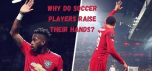 why do soccer players raise their hands